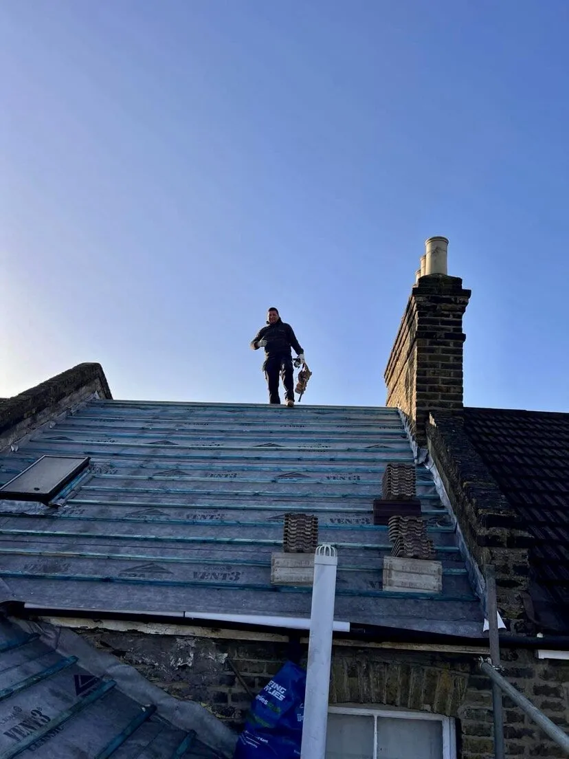 Worker putting his thumb up on roof for roof surveys